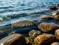 Stones under water with light refraction forming abstract patterns. Royalty Free Stock Photo