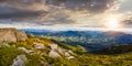 Stones in valley on top of mountain range at sunset