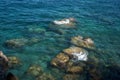 stones that are washed by the clean, transparent blue water of the Mediterranean Sea Royalty Free Stock Photo