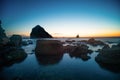 Stones in the water of the Pacific Ocean, with rocks in the water at sunset. Night landscape Royalty Free Stock Photo