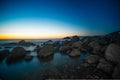 Stones in the water of the Pacific Ocean, with rocks in the water at sunset. Night landscape Royalty Free Stock Photo