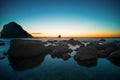 Stones in the water of the Pacific Ocean, with rocks in the water at sunset. Night landscape Royalty Free Stock Photo