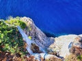 Stones in the water. Summer sea rocky coast view. Exciting sea and rocks. Rocks and blue sea. Cretan beach. Top view. Cliff and