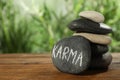 Stones with word Karma on wooden table, closeup. Space for text Royalty Free Stock Photo