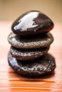 Stones, zen and wet rocks for hot stone massage at a spa for luxury and wellness. Peace, closeup and rock balance with Royalty Free Stock Photo