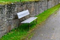 stonewall and bench near a walkingpath at cemetery