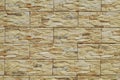 Stoneware cladding wall with stone effect. Colors are flaxen yellow, beige and brown. Royalty Free Stock Photo
