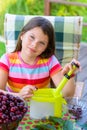 Stoning fresh cherries by young pretty girl in the garden Royalty Free Stock Photo