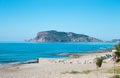 Stony beach and beautifull view to ancient fortress on the Alanya peninsula Turkey Royalty Free Stock Photo