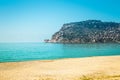 Stony beach and beautifull view to ancient fortress on the Alanya peninsula Turkey. Toned Royalty Free Stock Photo