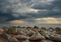 Stony beach by the sea. dramatic sky with sun rays Royalty Free Stock Photo