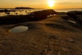 Stony coastline, quiet beautiful golden sunset on the sea. Summer nature background Royalty Free Stock Photo