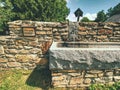 Stony fountain in nature with iron faucet. Natural resources