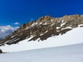 A stony mountain range that rises above the snowy plain. Royalty Free Stock Photo