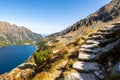 Stony mountain trail leading to Szpiglasowy Wierch Mount in Tatra Mountains, with crystal blue mountain lake, Poland Royalty Free Stock Photo