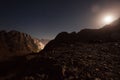 Mountains at night, lit with moonlight against sky background. Royalty Free Stock Photo