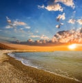 Stony sea beach at the dramatic sunset Royalty Free Stock Photo