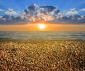Stony sea beach at the dramatic sunset Royalty Free Stock Photo