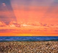 stony sea coast at the dramatic red sunset Royalty Free Stock Photo