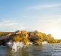 Stony sea coast with waves at the sunset Royalty Free Stock Photo