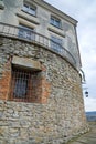 Stony wall with window and lamp