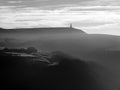 Stoodley pike in west yorkshire with morning mist in winter mono