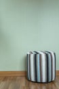 Stool in empty room against a green wall Royalty Free Stock Photo