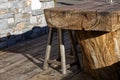 Stool and tables made from a single wooden trunk in a cottage