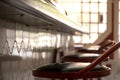 Stools arranged next to a bar counter with the background window and natural light Royalty Free Stock Photo