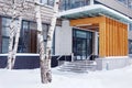 Stoop of modern building decorated with wooden panels