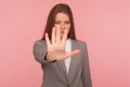 Stop, access prohibited! Portrait of strict lady boss in business suit standing with outstretched hand, warning expression