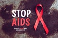 Stop aids text with red ribbon symbol of human immunodeficiency virus disease. dark background. aids concept