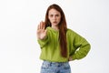 Stop. Angry ginger girl stretch hand to prohibit, reject and disapprove, decline something, say no, forbid action