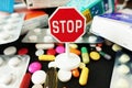 Stop antibiotics or medication excess with colorful pharmaceutical drugs with stop sign on top