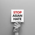 Stop Asian hate concept. hand holding card paper sheet with word stop Asian hate for poster of campaign Royalty Free Stock Photo