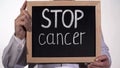 Stop cancer text on blackboard in doctor hands, disease therapy innovations Royalty Free Stock Photo