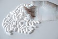 Stop commenting that it`s addictive. human hand on white pill background on empty space. Royalty Free Stock Photo