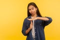 Stop control, need break! Portrait of displeased girl in denim shirt showing timeout gesture, warning of deadline