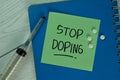 Stop Doping write on sticky notes isolated on Wooden Table