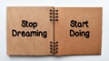 Stop dreaming, start doing, motivating quotation phrase. Inspirational motivating quote on notebook paper