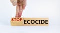 Stop ecocide symbol. Businessman turns a cube and changes words ecocide to stop ecocide. Beautiful white background, copy space.