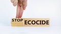 Stop ecocide symbol. Businessman turns a cube and changes words ecocide to stop ecocide. Beautiful white background, copy space.