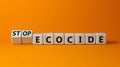Stop ecocide symbol. Turned wooden cubes with words stop ecocide. Beautiful orange background, copy space. Business, ecological