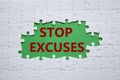 Stop excuses symbol. Concept words Stop excuses on white puzzle. Beautiful green background. Business and Stop excuses concept.