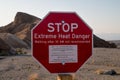 Stop! Extreme heat danger landmark red sign in the hot ridges of Zabriskie Point, Death Valley National Park, California, USA Royalty Free Stock Photo
