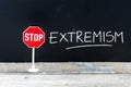 STOP EXTREMISM message written on chalkboard