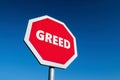 Stop GREED traffic sign to limit the cupidity and desire for money and luxury Royalty Free Stock Photo