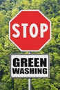 Stop Greenwashing concept with stop road sign in a rural scene with trees on background