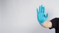 Stop hand sign with blue glove on white background Royalty Free Stock Photo