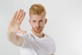 Stop hands sign. Young man in blank template white t shirt showing stop gesture. Redheaded and red beard guy isolated. hazard Royalty Free Stock Photo